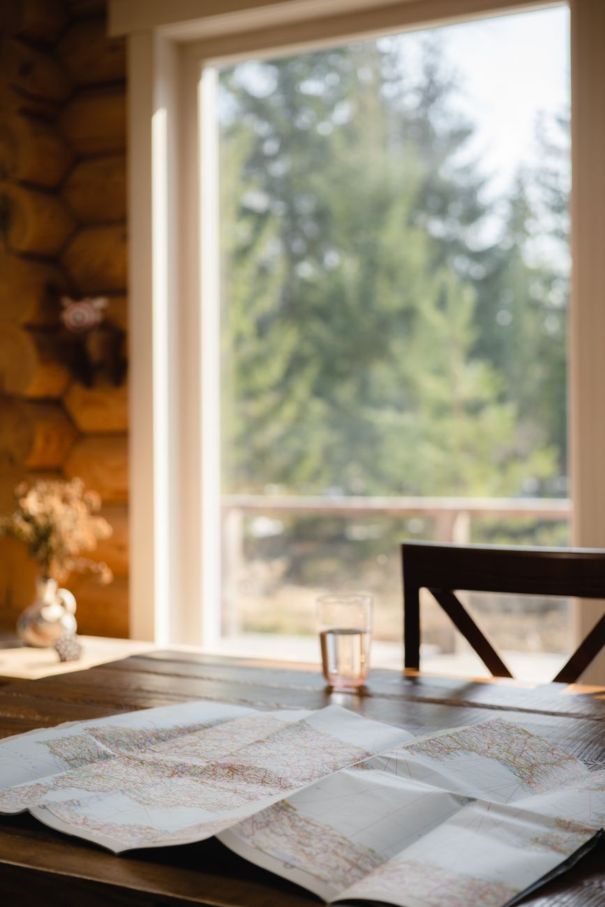 Travel writer examining maps in wooden lodge